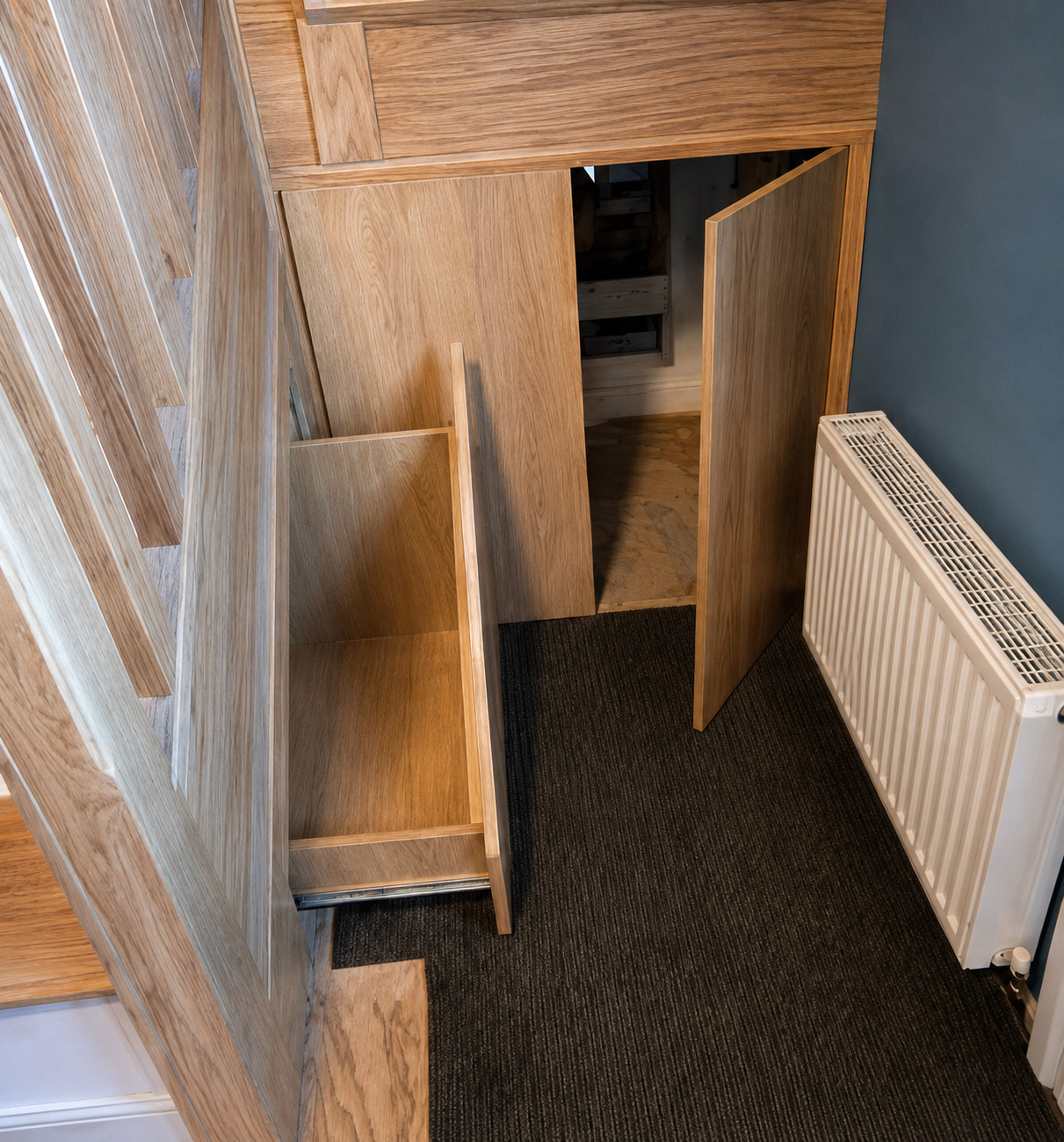 Bespoke understairs storage installation designed and fitted by Elite